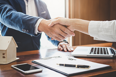 Real Estate Agent and Customer Shaking Hands